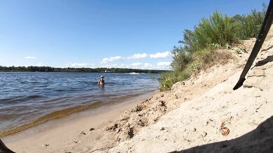 Fishermen swim past a beautiful nudist woman