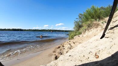 Fishermen swim past a beautiful nudist woman