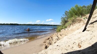 Fishermen swim past a beautiful nudist woman