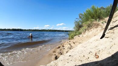 Fishermen swim past a beautiful nudist woman