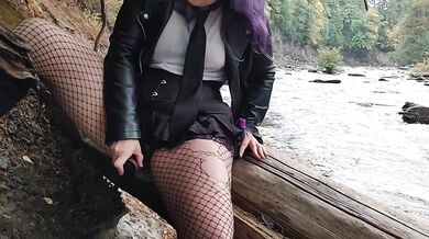 Milf fucks herself with huge dildo beside public river