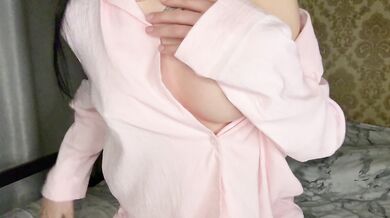 Brunette in pink pajamas gives herself pleasure with a big pink cock.