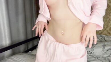 Brunette in pink pajamas gives herself pleasure with a big pink cock.