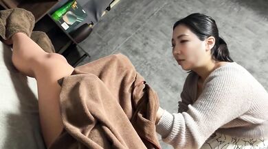 A girl in her twenties with big at the men's VIO hair removal salon gives a to a customer at work