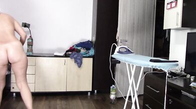 Sexy brunette doing naked chores around the house.