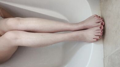 MILF shaving her legs sitting the the shower