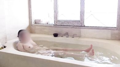 Age gap couple bathing in the resort bath.