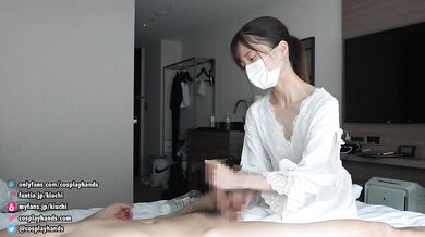 Japanese girls in negligee gives a guy a handjob while facesitting.
