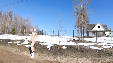Nude girl in a village in spring