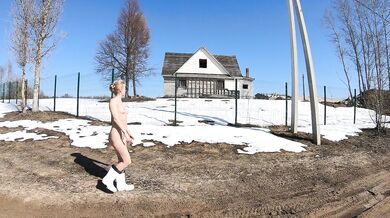 Nude girl in a village in spring