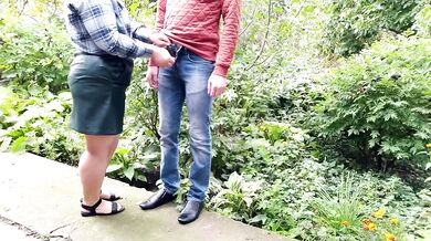 Mature milf holds a pissing stranger's cock