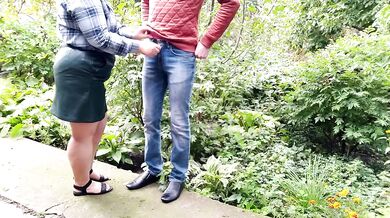 Mature milf holds a pissing stranger's cock