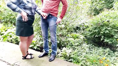 Mature milf holds a pissing stranger's cock
