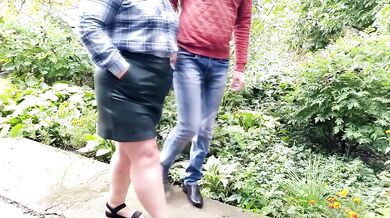 Mature milf holds a pissing stranger's cock
