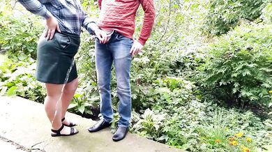 Mature milf holds a pissing stranger's cock