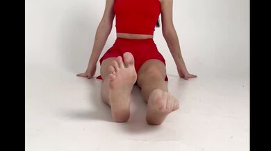 stretching long legs in short red skirt