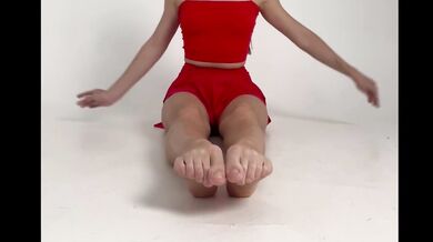stretching long legs in short red skirt