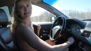 Nude girl drives car on dirty road