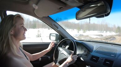 Nude girl drives car on dirty road