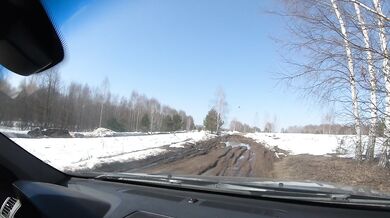 Nude girl drives car on dirty road
