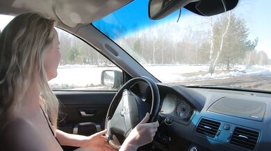 Nude girl drives car on dirty road