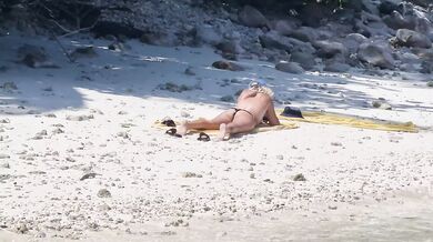 Milf relaxing on beach and masturbation