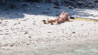Milf relaxing on beach and masturbation
