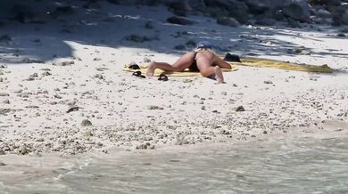 Milf relaxing on beach and masturbation