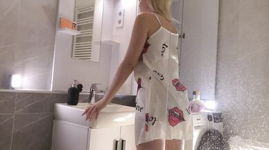 Sexy beauty cute blonde horny girl in pink panties and with a satin nightie does the bathroom routine before going to the bed