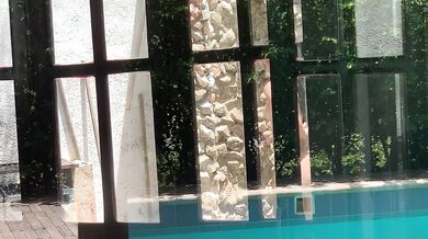 My neighbors are taking a shower on the patio. I must go there to see it up close