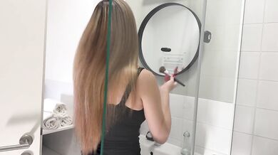 Amazingly beautiful college girl in the bathroom with a super skirt miniskirt shows her ass