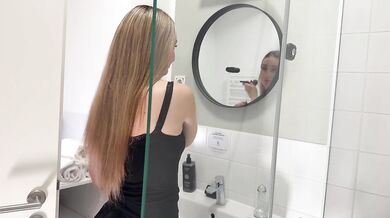 Amazingly beautiful college girl in the bathroom with a super skirt miniskirt shows her ass