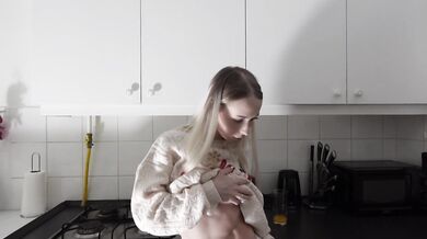 Amazingly beautiful petite blonde hot college girl in her dormitory kitchen getting ready for Christmas Party