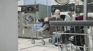 A lonely girl receives help from a stranger at the laundromat…
