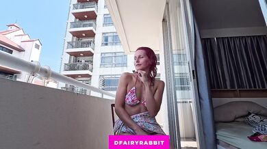 BALCONY EXHIBITIONIST! Petite redhead spreading her legs for a toy session outdoors