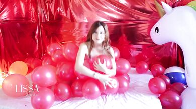Skinny redhead has fun popping balloons with her ass, until her pussy is wet