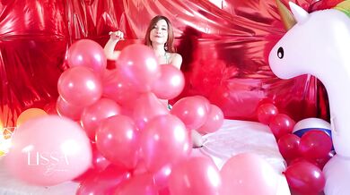 Skinny redhead has fun popping balloons with her ass, until her pussy is wet