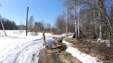 Naked girl in a winter village