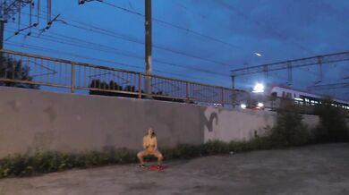 PUBLIC EXTREME! A crazy girl is jerking off in front of a train and pissing on the tracks