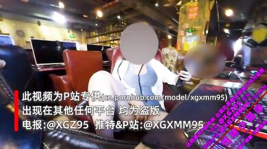 Masturbating with a vibrator in an internet café with a stranger behind him