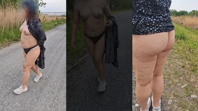 Exhibitionist mature woman quietly takes off her clothes on the street without knowing if anyone is watching her