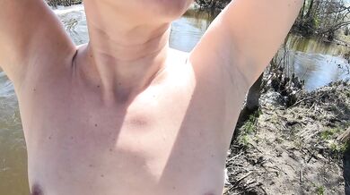 Naked girl near a stormy river