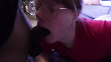 Cute White girl in glasses gives throat to a Black Cock