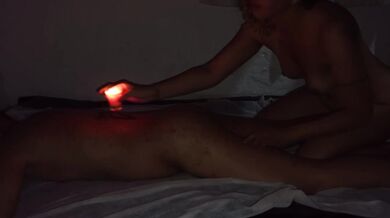 Romantic couple's massage with candles and gliding movements.