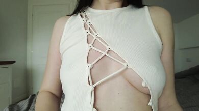 Solo girl plays with and caresses her hard nipples. Natural tits close-up