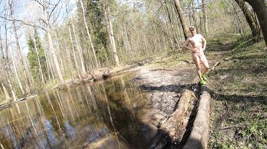 Naked girl crosses a puddle