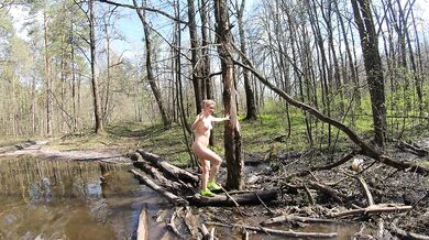 Naked girl crosses a puddle