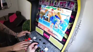Two young women play video games and then have strapon sex