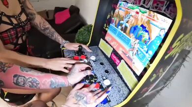 Two young women play video games and then have strapon sex