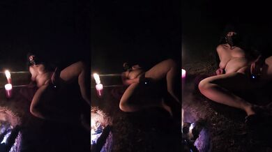 Curvy girl playing with hot wax by camp fire